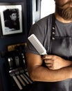 Trendy bearded young barber inside barber shop ready for the clients