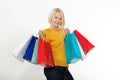 Trendy beautiful happy blond woman carrying colorful tote bags shopping isolated on white banner background with copy space Royalty Free Stock Photo