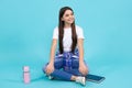 Trendy beautiful teenage model posing on blue studio background. Child girl in t-shirt and jeans. Studio shot. Teen Royalty Free Stock Photo