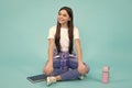 Trendy beautiful teenage model posing on blue studio background. Child girl in t-shirt and jeans. Studio shot. Teen Royalty Free Stock Photo