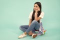 Trendy beautiful teenage model posing on blue studio background. Child girl in t-shirt and jeans. Studio shot. Teen Royalty Free Stock Photo