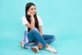 Trendy beautiful teenage model posing on blue studio background. Child girl in t-shirt and jeans. Studio shot. Teen Royalty Free Stock Photo