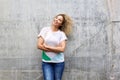 Trendy beautiful woman standing with arms crossed