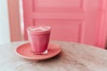 Trendy beetroot latte with latte art and flower petals Royalty Free Stock Photo