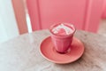 Trendy beetroot latte with latte art and flower petals Royalty Free Stock Photo