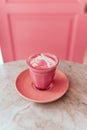 Trendy beetroot latte with latte art and flower petals Royalty Free Stock Photo