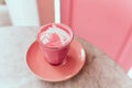 Trendy beetroot latte with latte art and flower petals Royalty Free Stock Photo