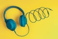 Trendy blue headphone on yellow background. Music concept. Royalty Free Stock Photo