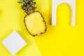 Trendy bright yellow background with geometric forms and podiums for product presentation. Pineapple and podiums to show products