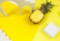 Trendy bright yellow background with geometric forms and podiums for product presentation. Pineapple and podiums to show products