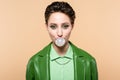 trendy brunette woman blowing bubble gum