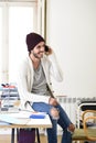 Trendy businessman in beanie and cool hipster informal look talking happy on mobile phone Royalty Free Stock Photo