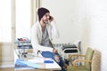 Trendy businessman in beanie and cool hipster informal look talking happy on mobile phone Royalty Free Stock Photo