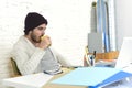 Trendy businessman in cool hipster beanie drinking coffee working happy in at modern home office Royalty Free Stock Photo