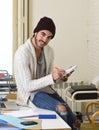 Trendy businessman in cool hipster beanie and informal look writing on pad working at home office Royalty Free Stock Photo