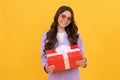 trendy cheerful child in sunglasses and suit hold present box on yellow background, birthday Royalty Free Stock Photo