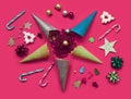 Christmas pattern made with creme cones ,candy, tree snowflake,bauble decoration on bright pink background. Royalty Free Stock Photo