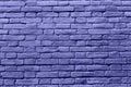 Trendy color very peri brick wall background. Painted stone backdrop. Purple tile texture.