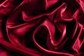 Trendy color viva magenta smooth silk background. Close up. Elegant bright satin with waves. Fabric backdrop, view from