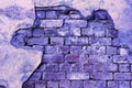 Trendy Color of the year 2022 Very Peri. Brick background grunge texture. Stone lilac brick wall. Wall of an old ruined brick Royalty Free Stock Photo