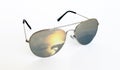 Trendy cool silver sunglasses with the reflection of a beautiful sunset over an ocean Royalty Free Stock Photo