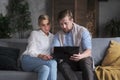 Trendy couple business partner working together use laptop at cozy apartment browsing web searching Royalty Free Stock Photo