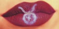 Trendy Creative lip makeup. Closeup Shiny glossy lips with Tauru