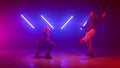 Trendy dancers battling playfully in freestyle dance. Couple dancing hip hop.