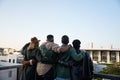 Trendy, Diverse group of friends standing together on rooftop at party in the city. Looking at beautiful view Royalty Free Stock Photo