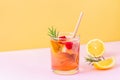 Trendy exotic summer drink with disposable paper straw and rosemary on bicolor background