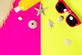 Trendy fashion beach accessories on a bright colorful background. Dried starfish, shells, a bottle of sunscreen lotion, a fragment Royalty Free Stock Photo