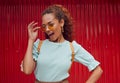 Trendy, fashion of black woman cool sunglasses with a playful attitude on red background outside. Happy girl model with Royalty Free Stock Photo