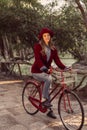 Trendy fashion girl riding bike on fall season Royalty Free Stock Photo