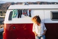 Trendy fashion young woman people outside a cozy and beautiful vintage retro van with socks and shoes - perfect vanlife travel