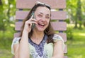 Trendy fashionable beautiful woman calling talking nd laughs on her cellphone in the park. Beautiful young woman talking on cell Royalty Free Stock Photo