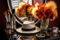 a trendy fedora on a mirrored dressing table with an array of makeup brushes