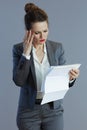 trendy female worker in gray suit isolated on grey Royalty Free Stock Photo