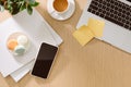 Trendy feminine home office workspace. White office desk. Laptop, coffee cup and macaroons, phone, notebook, pencil. Flat lay, top Royalty Free Stock Photo