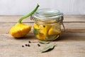 Trendy Fermented vegetables buch pumpkin patisson in glass jar on wooden table. Royalty Free Stock Photo