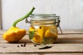 Trendy Fermented vegetables buch pumpkin patisson in glass jar on wooden table. Royalty Free Stock Photo