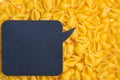 Trendy flat view closeup yellow macaroni. Conchiglie. Top view, flat lay. Nature concept. Texture background, pattern. Restaurant