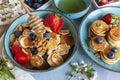 Trendy food during coronavirus Covid-19 lockdown quarantine - tiny pancakes. Poffertjes, Little Dutch pancakes. Breakfast for kids