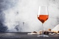 Trendy food and drink, orange wine in glass, gray table background, space for text, selective focus