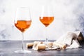 Trendy food and drink, orange wine in glass, gray table background, space for text, selective focus