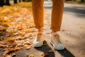 Trendy footwear on display as a woman walks in the park