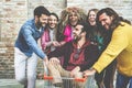 Trendy friends having fun pushing trolley - Young students people enjoyin time together - Fashion, youth, sale and friendship Royalty Free Stock Photo