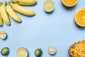 Trendy fruit set on a blue background, mini bananas, limes, oranges,lined frame, space for text, top view