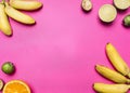 Trendy fruit set on a bright pink background, mini bananas, limes, oranges,lined frame, space for text, top view