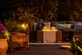 Furniture, lights, lanterns and candles in the garden at night Royalty Free Stock Photo