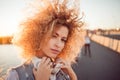 Trendy girl with large headphones on a city walk, close up. Royalty Free Stock Photo